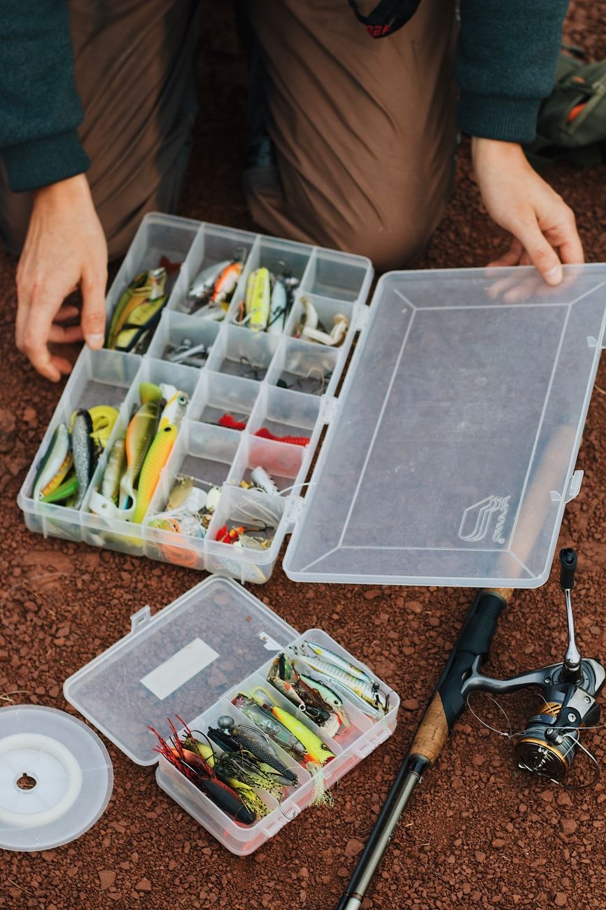 Close-up of spinning reel and assorted predator lures